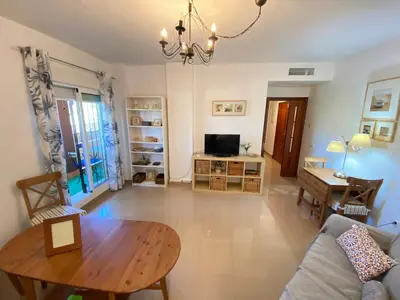 a living room with a table and a couch at Apartamento Mirador del Coto in Sanlúcar de Barrameda