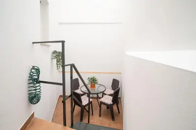 a dining room with a table and chairs at Apartamento Rosole in Sanlúcar de Barrameda