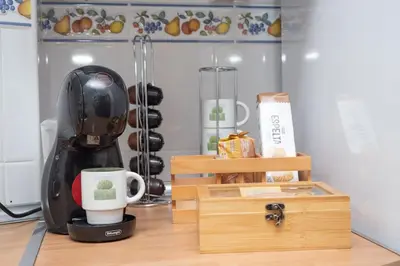 a coffee maker and a cup on a table at Apartamento Rosole in Sanlúcar de Barrameda