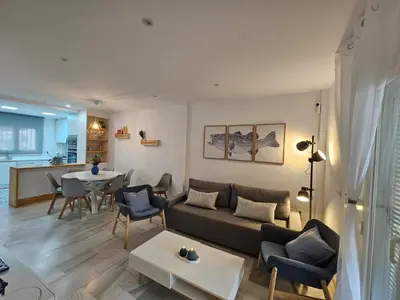 a living room with a couch and a table at Casa en La Barrosa vista mar in Chiclana de la Frontera