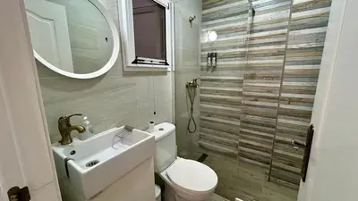 a bathroom with a toilet and a sink and a mirror at Estudio de Mia in Cádiz