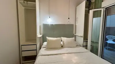 a bedroom with a bed with two pillows and a mirror at Estudio de Mia in Cádiz
