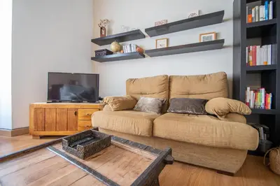 a living room with a couch and a flat screen tv at Apartamento Santa M Serenity Cadiz in Cádiz
