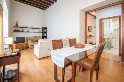 a dining room and living room with a table and chairs at Apartamento Santa M Serenity Cadiz in Cádiz