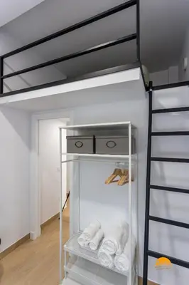 a bunk bed with a ladder in a room at Brisa de Verano by Cadiz Time in Cádiz