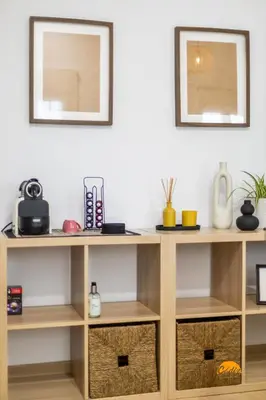 a wooden shelf with two baskets and two mirrors at Brisa de Verano by Cadiz Time in Cádiz