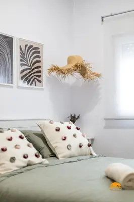 a bedroom with a bed with pillows on it at Brisa de Verano by Cadiz Time in Cádiz