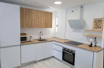 a white kitchen with white cabinets and a sink at GINVA - Apartamento en pleno centro 3 in El Puerto de Santa María