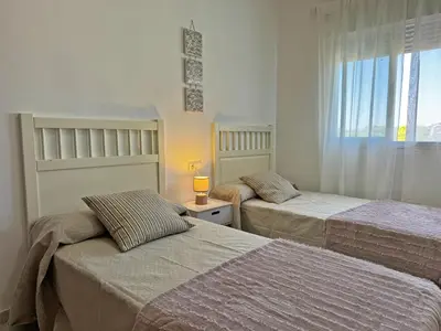 a bedroom with two beds and a window at Apartamento Minotauro - Ole Solutions in Jerez de la Frontera