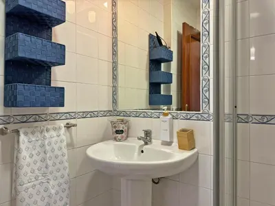 a bathroom with a sink and a mirror at Apartamento Minotauro - Ole Solutions in Jerez de la Frontera