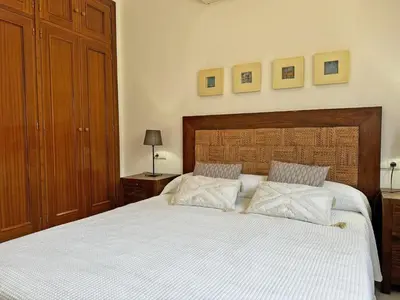 a bedroom with a large white bed with two pillows at Apartamento Minotauro - Ole Solutions in Jerez de la Frontera