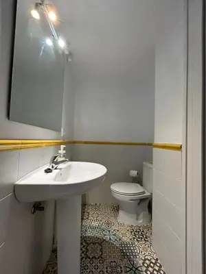 a white bathroom with a sink and a toilet at Quilla Puerto Sherry in El Puerto de Santa María