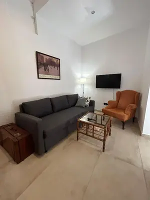 a living room with a couch and a chair at Casa del Reloj - Puerto De Sta María in El Puerto de Santa María