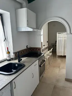 a kitchen with a sink and a counter top at Casa del Reloj - Puerto De Sta María in El Puerto de Santa María