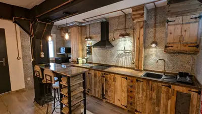 a kitchen with wooden cabinets and a sink at Loft Duplex La Industrial Playa in Cádiz
