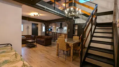 a room with a staircase leading to a living room at Loft Duplex La Industrial Playa in Cádiz