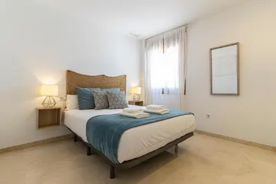 a bedroom with a bed with two towels on it at Penthouse City Center - Jerez in Jerez de la Frontera