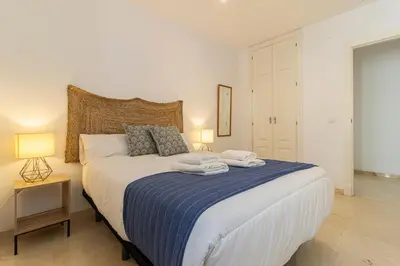 a bedroom with a large bed with towels on it at Penthouse City Center - Jerez in Jerez de la Frontera