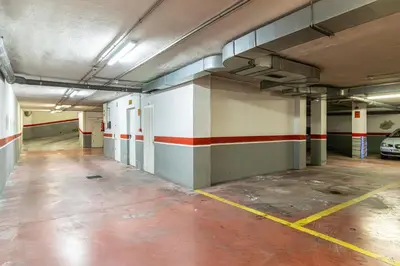 an empty parking garage with a car parked in it at Penthouse City Center - Jerez in Jerez de la Frontera