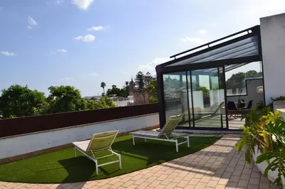 a house with two chairs on the roof at Penthouse City Center - Jerez in Jerez de la Frontera