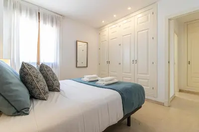 a bedroom with a large bed with towels on it at Penthouse City Center - Jerez in Jerez de la Frontera