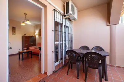 a dining room with a table and chairs at Apartamento Al Ándalus 43 in Chiclana de la Frontera