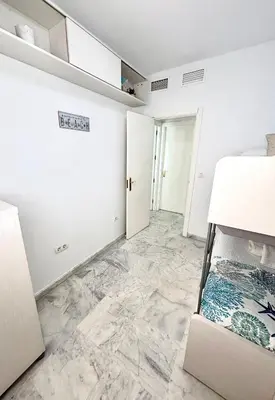 a room with white walls and marble floors at Apartamento Atlántico in Rota