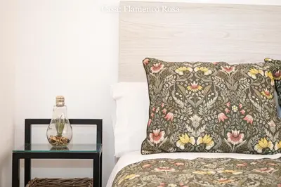 a bed with a pillow and a side table with a lamp at Casa Rural Mirador del Guadalquivir-Refugio con Piscina y Chimenea in Trebujena