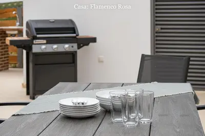 a wooden table with plates and glasses on it at Casa Rural Mirador del Guadalquivir-Refugio con Piscina y Chimenea in Trebujena