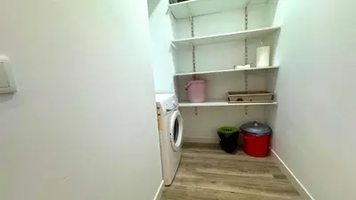 a small laundry room with a washer and dryer at Sibs Sanlúcar Lucero Edificio Unico Terraza Tranquilo in Sanlúcar de Barrameda