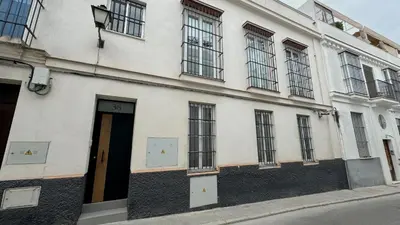 a white building with windows and a door at Sibs Sanlúcar Lucero Edificio Unico Terraza Tranquilo in Sanlúcar de Barrameda