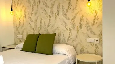 a bedroom with a bed with green pillows at Sibs Sanlúcar Lucero Edificio Unico Terraza Tranquilo in Sanlúcar de Barrameda