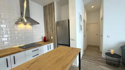 a kitchen with a wooden counter top in a room at Sibs Sanlúcar Lucero Edificio Unico Terraza Tranquilo in Sanlúcar de Barrameda