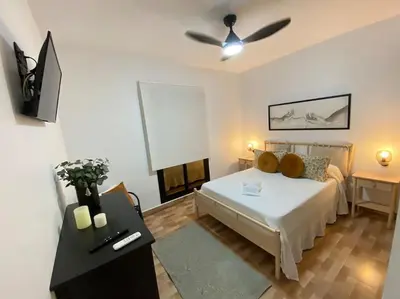 a bedroom with a bed and a ceiling fan at Villa con piscina Camino Doñana in Sanlúcar de Barrameda