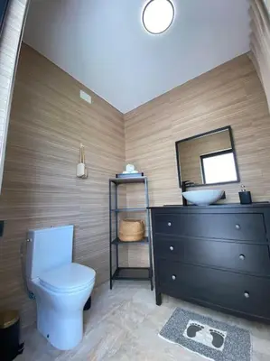 a bathroom with a toilet and a sink and a mirror at Villa con piscina Camino Doñana in Sanlúcar de Barrameda