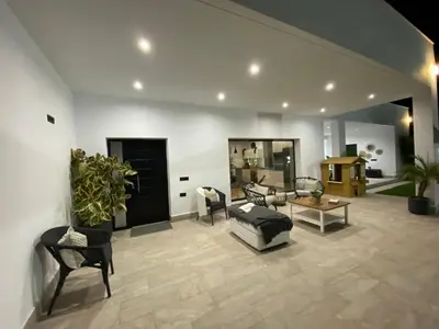 a living room with a couch and a table at Villa con piscina Camino Doñana in Sanlúcar de Barrameda