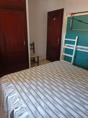 a bedroom with a bed and a bunk bed at Casa Mar Baltico a 200 m de la Playa La Barrosa in Chiclana de la Frontera