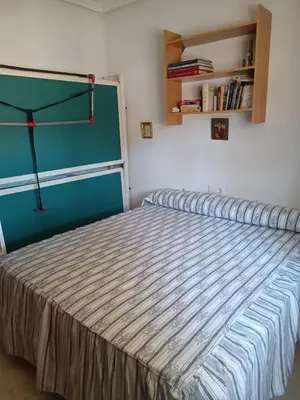 a bedroom with a bed with a blue wall at Casa Mar Baltico a 200 m de la Playa La Barrosa in Chiclana de la Frontera