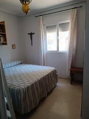 a bedroom with a bed and a window at Casa Mar Baltico a 200 m de la Playa La Barrosa in Chiclana de la Frontera