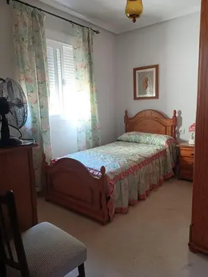a bedroom with a bed and a window at Casa Mar Baltico a 200 m de la Playa La Barrosa in Chiclana de la Frontera