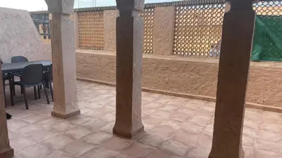 a patio with columns and a table and chairs at Bahia Sur Deluxe in San Fernando