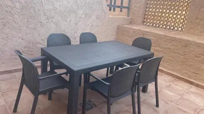 a black table and chairs with a blue table and chairs at Bahia Sur Deluxe in San Fernando