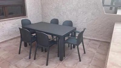 a black table and chairs in a room at Bahia Sur Deluxe in San Fernando