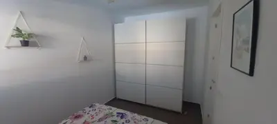 a white room with a bed and a cabinet at Sanlucarshine apartamento con piscina in Sanlúcar de Barrameda