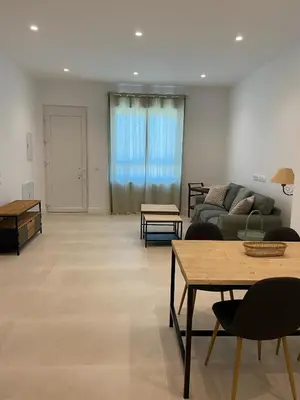 a living room with a couch and tables at Apartamentos a estrenar de dos dormitorios in San Fernando