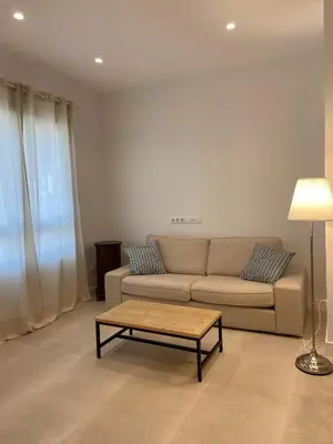 a living room with a couch and a coffee table at Apartamentos a estrenar de dos dormitorios in San Fernando