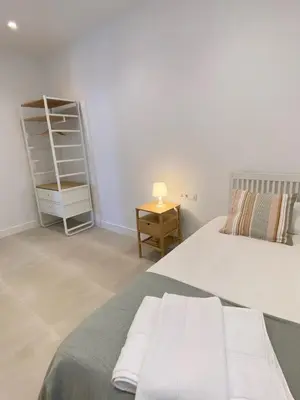 a bedroom with a bed and a book shelf at Apartamentos a estrenar de dos dormitorios in San Fernando