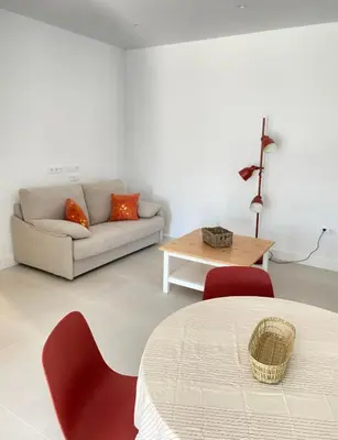 a living room with a couch and a table at Apartamentos a estrenar de dos dormitorios in San Fernando