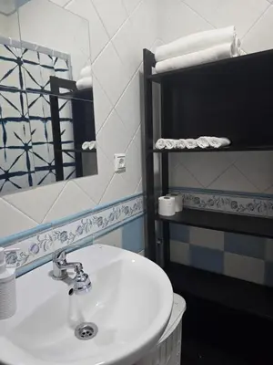 a bathroom with a sink and a mirror and a toilet at Sancti Petri in Chiclana de la Frontera