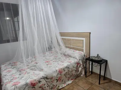 a bedroom with a bed with a mosquito net at Sancti Petri in Chiclana de la Frontera